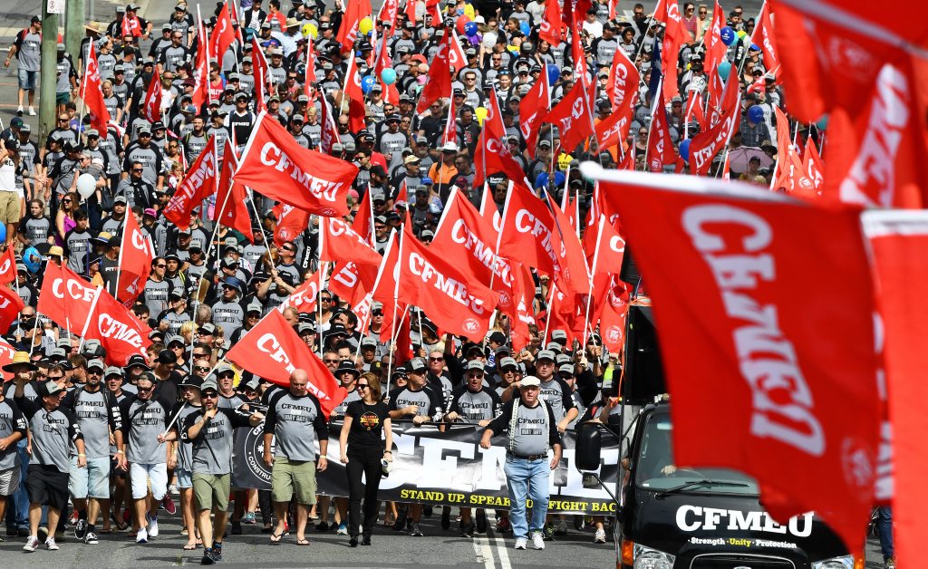 CMFEU members are seen as part of Queensland Unions celebrating their holiday restoration during the Labour Day March in Brisbane, Monday, May 2, 2016. The public holiday was shifted to the second half of the year by the former LNP government to reduce impact on businesses before the Labor party reversed the change. (AAP Image/Dave Hunt) NO ARCHIVING CMFEU members are seen as part of Queensland Unions celebrating their holiday restoration during the Labour Day March in Brisbane, Monday, May 2, 2016. The public holiday was shifted to the second half of the year by the former LNP government to reduce impact on businesses before the Labor party reversed the change. (AAP Image/Dave Hunt) NO ARCHIVING